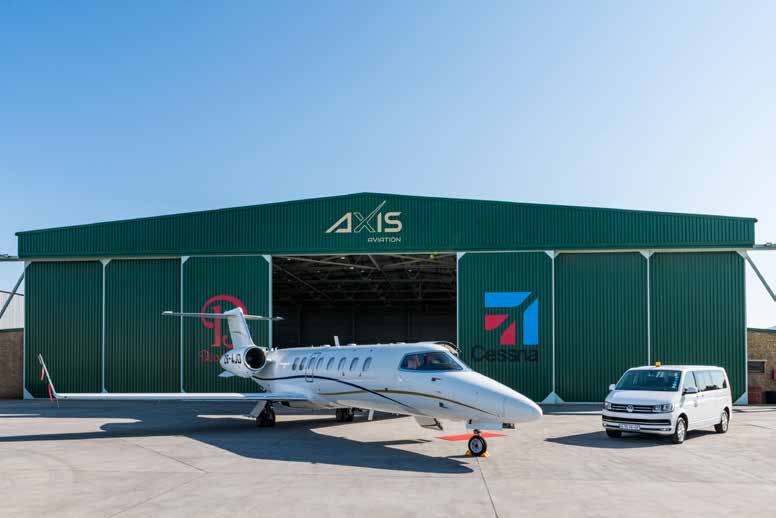 AXIS-branded hangar at Lanseria with a business jet and crew shuttle outside