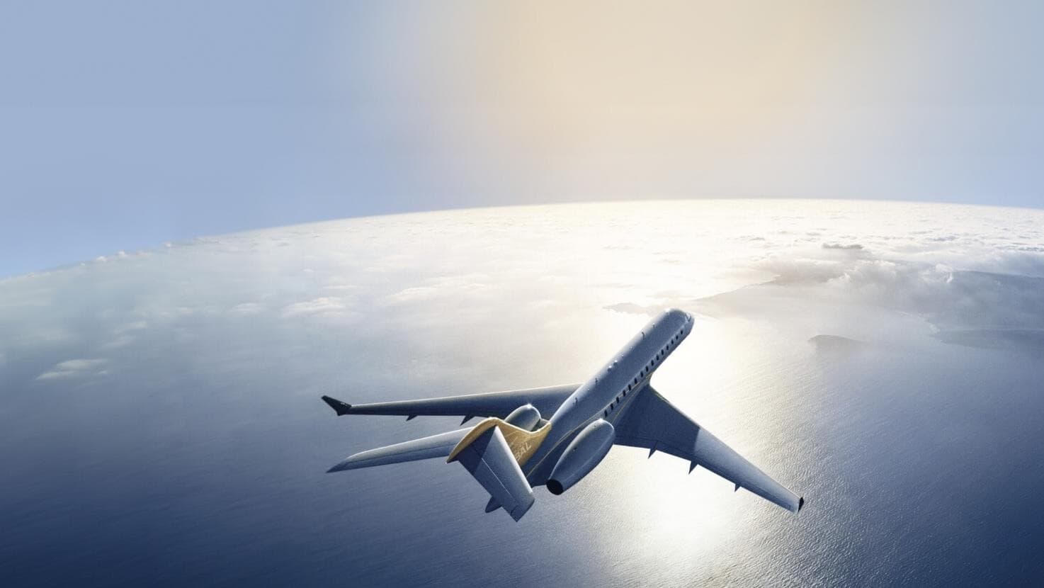 A privately managed jet banking over open ocean in soft daylight